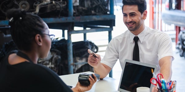 Business man using his card to make a transaction