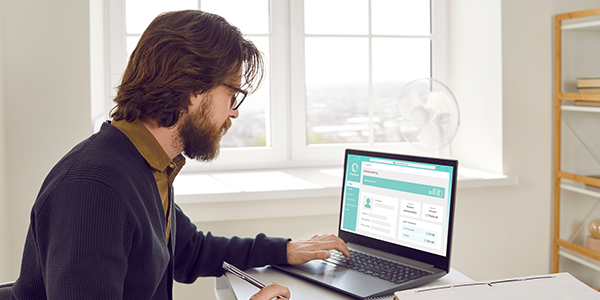 Father viewing finances on laptop